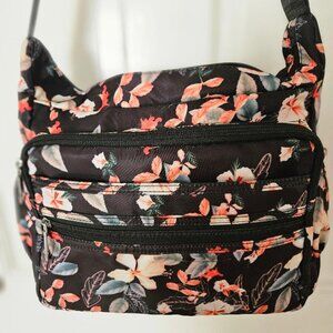 Black nylon w/ floral design shoulder bag w/ multiple pockets/compartments.